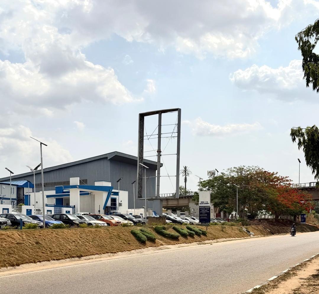 ABV-003 · Static Airport Billboard — Nnamdi Azikiwe International Airport Beside NCAA, Abuja advertising face and surrounding environment