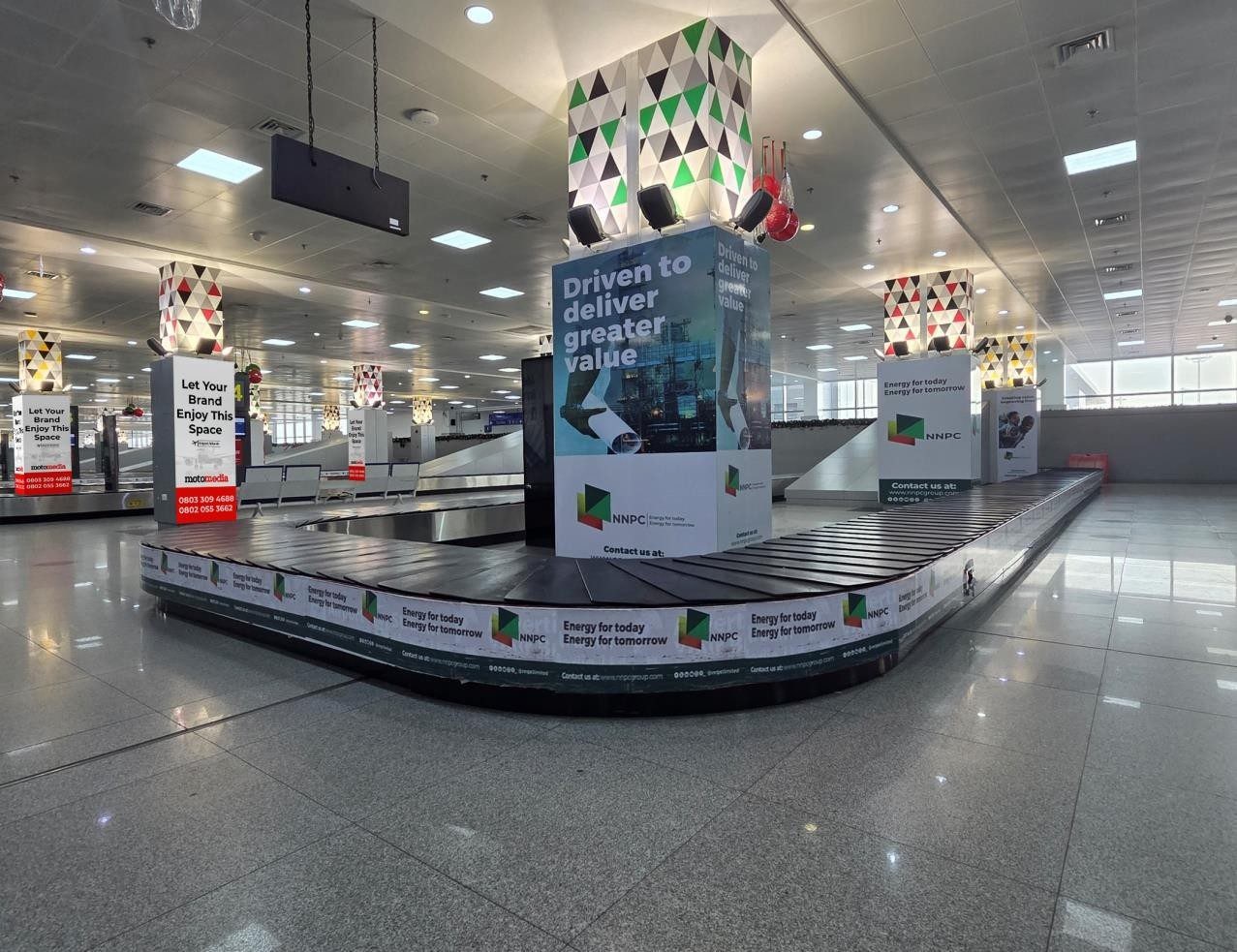 ABV-067 · Airport Branding — Baggage Claim Carousel & Pillars, Abuja Airport advertising face and surrounding environment