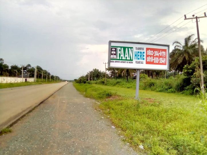 QOW-001 · Static Backlit Billboard — Okpala Junction, Access Road advertising face and surrounding environment