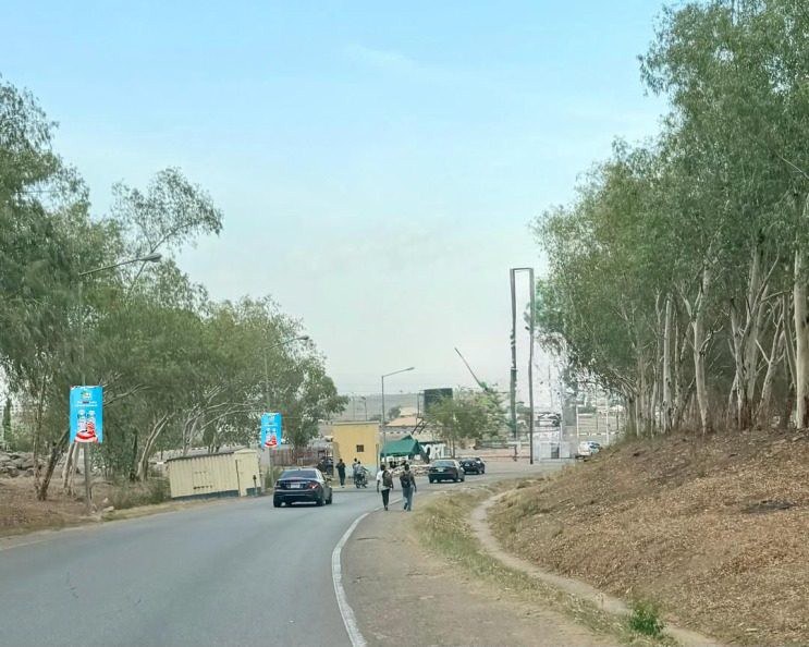 ABV-030 · Lamppost Banners — Bill Clinton Drive by Police Post, Abuja Airport advertising face and surrounding environment