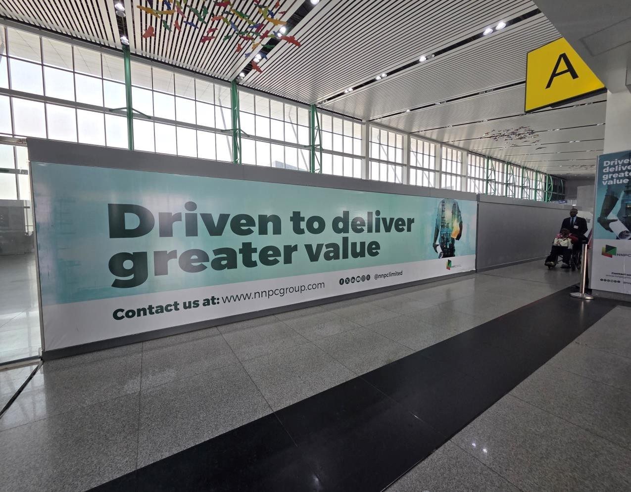 ABV-043 · Airport Lightbox — Nnamdi Azikiwe International Airport, Departure Hall Immigration Entrance advertising face and surrounding environment