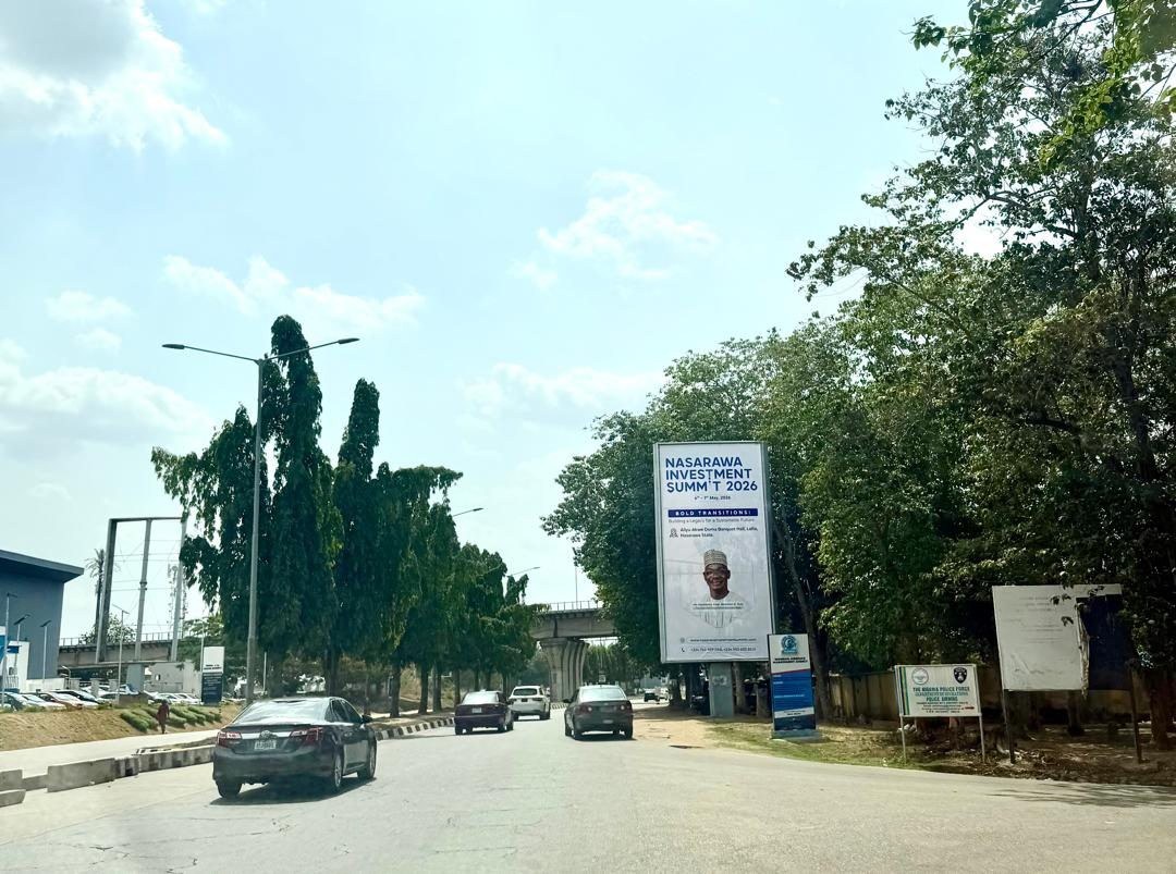 ABV-002 · Static Airport Billboard — Nnamdi Azikiwe International Airport Entrance, Abuja advertising face and surrounding environment