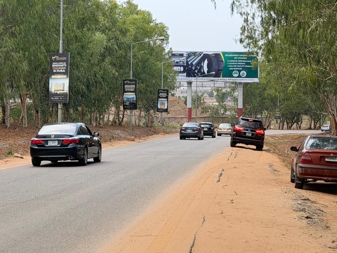 ABV-028 · Airport Static Billboard — Forecourt Exit 3, Abuja advertising face and surrounding environment