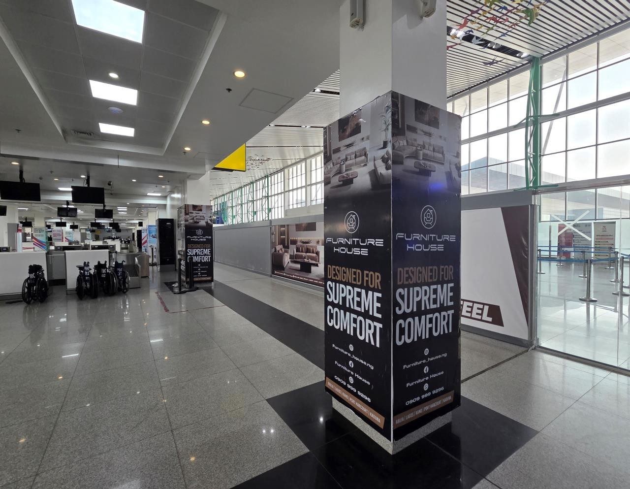 ABV-045 · Airport Pillar — Nnamdi Azikiwe International Airport, Departure Hall Screening Pillars advertising face and surrounding environment