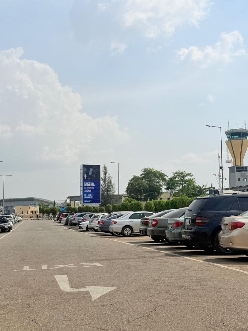 ABV-010 · Static Billboard — Nnamdi Azikiwe International Airport, VIP Car Park / Exit Private Wing (1) advertising face and surrounding environment
