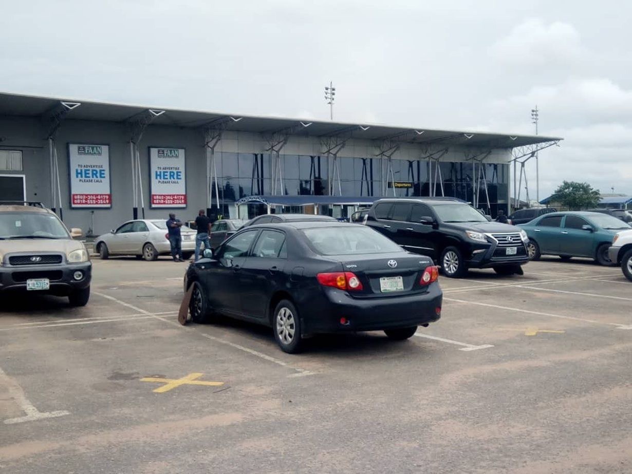 QOW-007 · Airport Billboard — Sam Mbakwe International Airport, Owerri, Departure Entrance Gate advertising face and surrounding environment