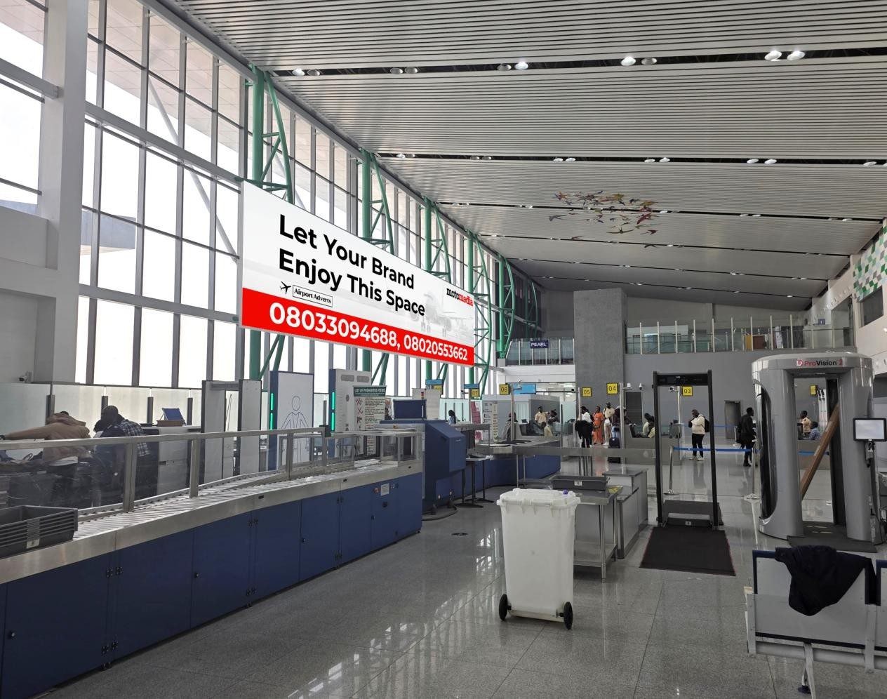 ABV-051 · Static Wall Drape — Nnamdi Azikiwe International Airport, Departure Escalator advertising face and surrounding environment