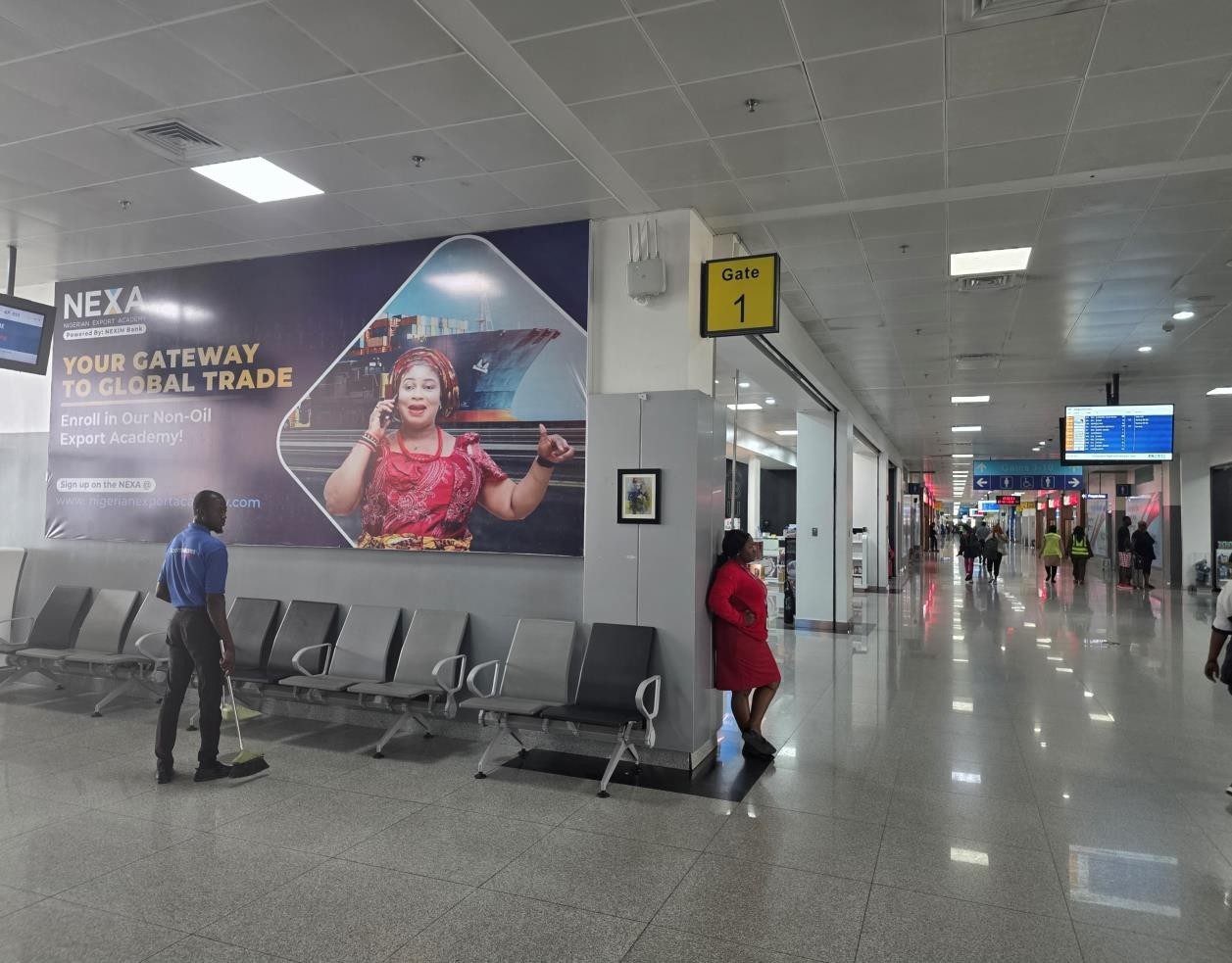 ABV-057 · Airport Static Lightbox — All Departure Gates Walkway, Nnamdi Azikiwe International Airport advertising face and surrounding environment