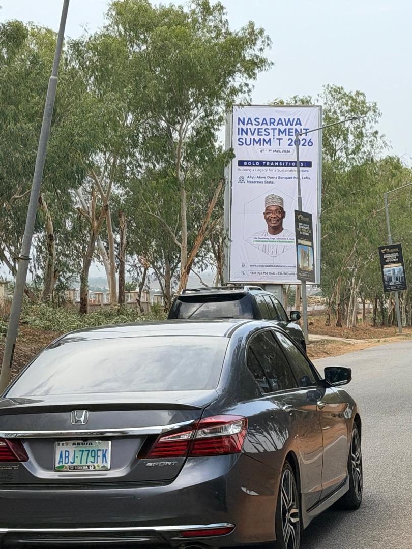 ABV-027 · Airport Static Billboard — Forecourt Exit 2, Abuja advertising face and surrounding environment