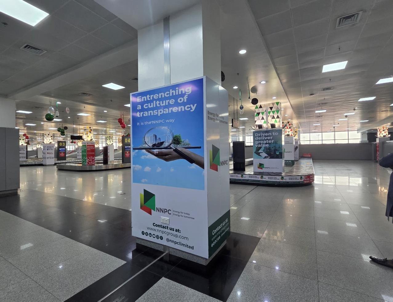 ABV-063 · Pillar Branding — Nnamdi Azikiwe International Airport, Arrival Baggage Claim advertising face and surrounding environment