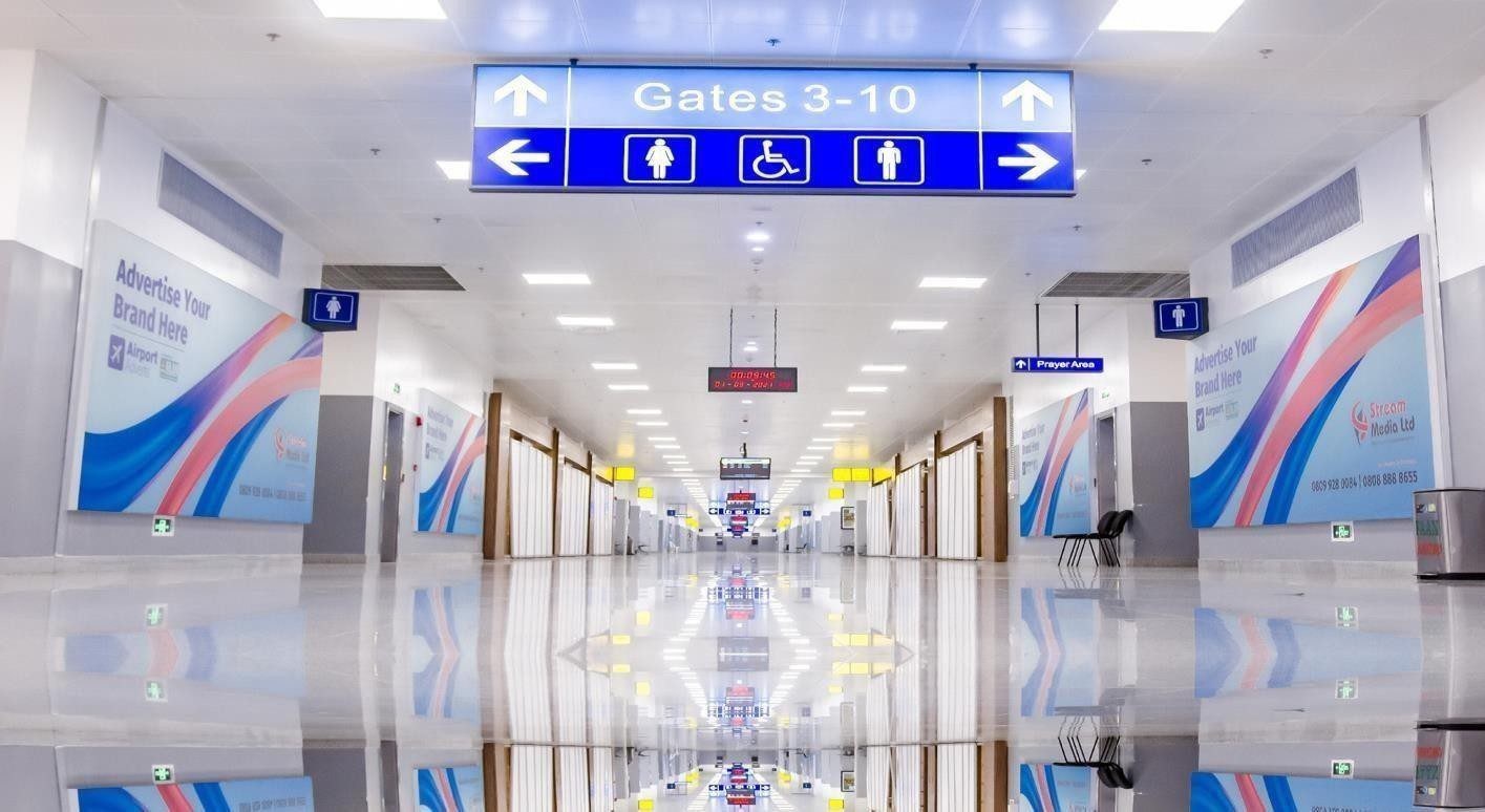ABV-058 · Airport Static Lightbox — All Departure Gates Walkway (2), Nnamdi Azikiwe International Airport advertising face and surrounding environment