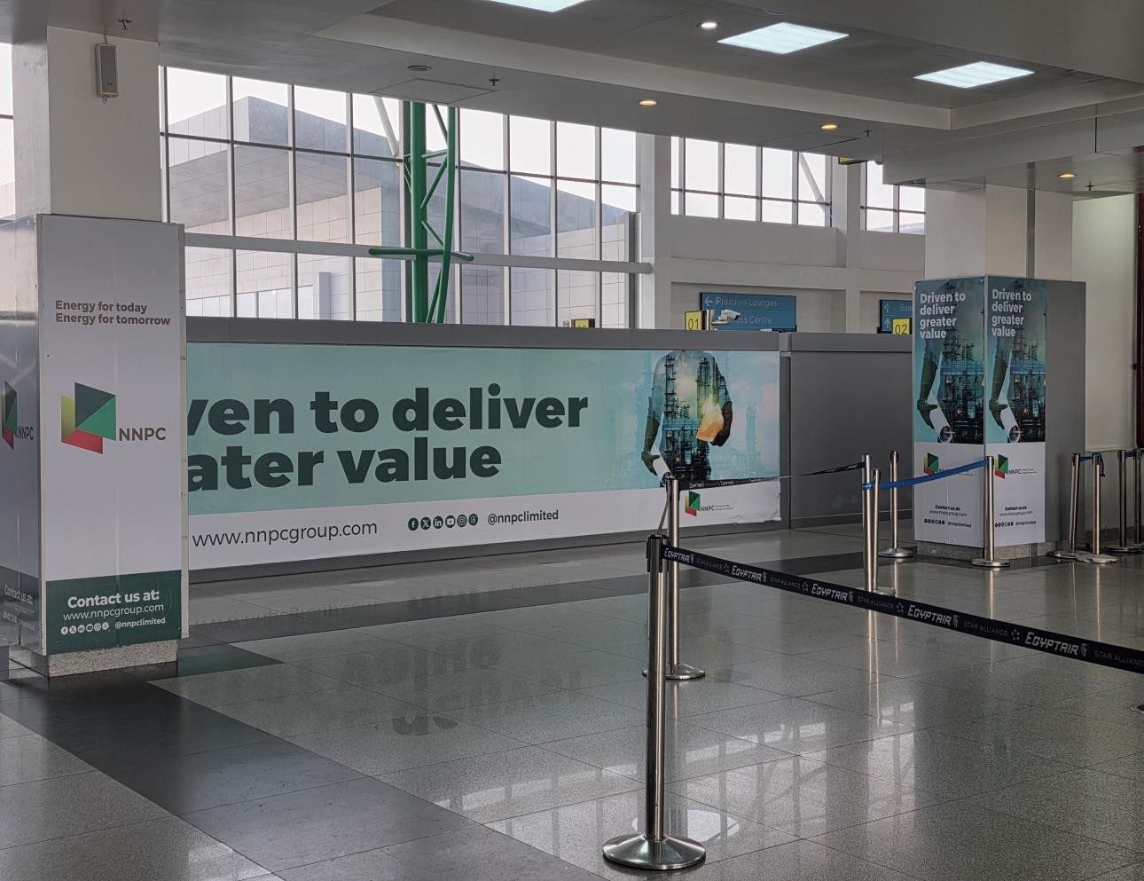 ABV-046 · Airport Static Pillar — Nnamdi Azikiwe International Airport Departure Hall (Check-In 3), Abuja advertising face and surrounding environment
