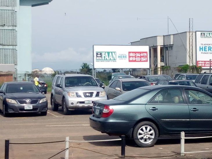 QOW-005 · Static Landscape Billboard — Arrival Exit Gate, Terminal Forecourt advertising face and surrounding environment
