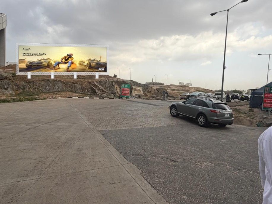 ABV-018 · Static Billboard, Nnamdi Azikiwe International Airport — Domestic Airport Carpark advertising face and surrounding environment