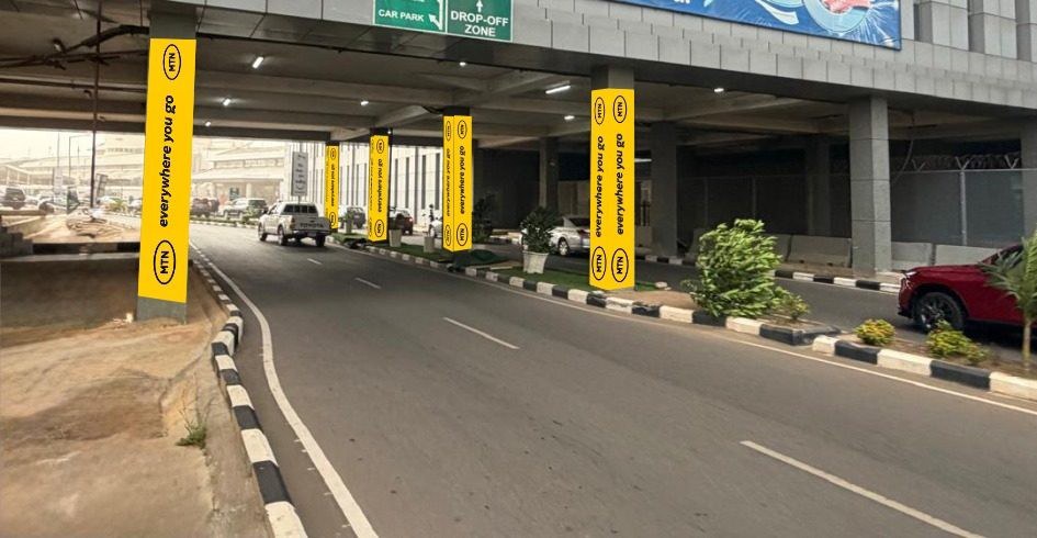 ABV-015 · Pillar Branding — Domestic Terminal Drop Off Zone, Nnamdi Azikiwe International Airport advertising face and surrounding environment