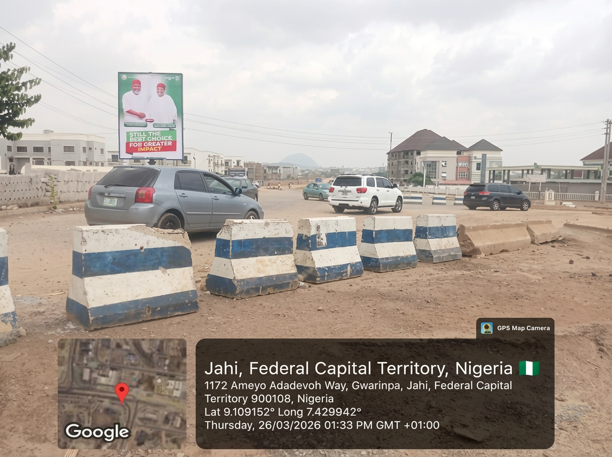 Portrait – Jahi Gwarimpa Road opp. NNPC by Shafa Police advertising face and surrounding environment