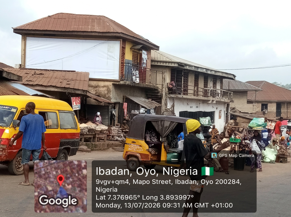 Ibadan wall drape – Mapo Street, Orita Merin Market advertising face and surrounding environment